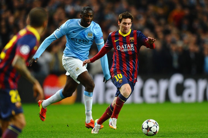 MANCHESTER, ENGLAND - FEBRUARY 18:  Lionel Messi of Barcelona competes with Yaya Toure of Manchester City during the UEFA Champions League Round of 16 first leg match between Manchester City and Barcelona at the Etihad Stadium on February 18, 2014 in Manchester, England.  (Photo by Laurence Griffiths/Getty Images)